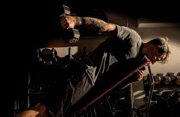 Man is working out with weights at the gym